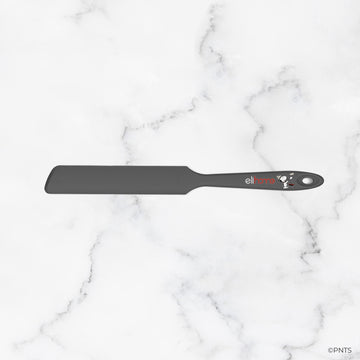 Black spatula with brand logo on a marble background