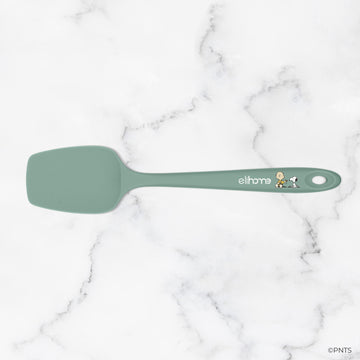 Green spatula with 'elihome' branding on a marble background