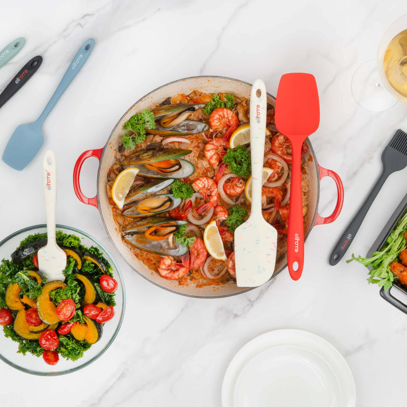 Elihome silicone kitchen utensils including spatulas, spoons, and brushes displayed with gourmet dishes on marble countertop