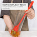 Elihome skinny silicone spatula used as a jar scraper, demonstrating how its 11-inch long handle reaches into a tall glass container to scoop olives. Text reads: "Deep Scoops, Easy Reach. Long handle for various containers and blender."