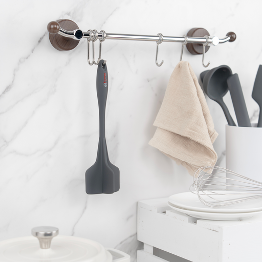 Elihome Classic Chopper in Grey hanging from a kitchen rail beside a linen towel and a crock of utensils on a marble wall