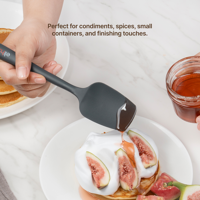 Hand using an Elihome Mini silicone spoonula in Gray to spoon honey over figs and cream on pancakes, perfect for condiments, spices, small containers and finishing touches