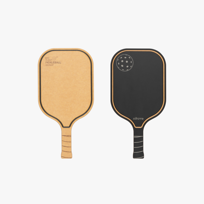 Elihome pickleball paddle cutting board shown from both sides, natural wood fiber engraved with Eat Sleep Pickleball Repeat and a reversible black serving side